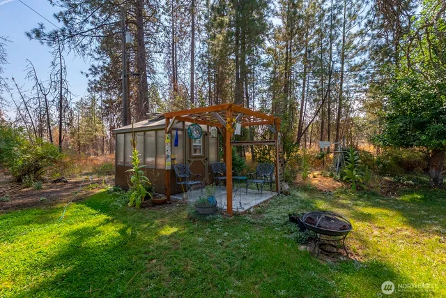 a view of a patio with table and chairs under an umbrella