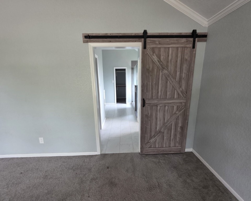 129 Corral Court Angleton, TX 77515 - Photo 13 of 26 Barn door to the primary bath