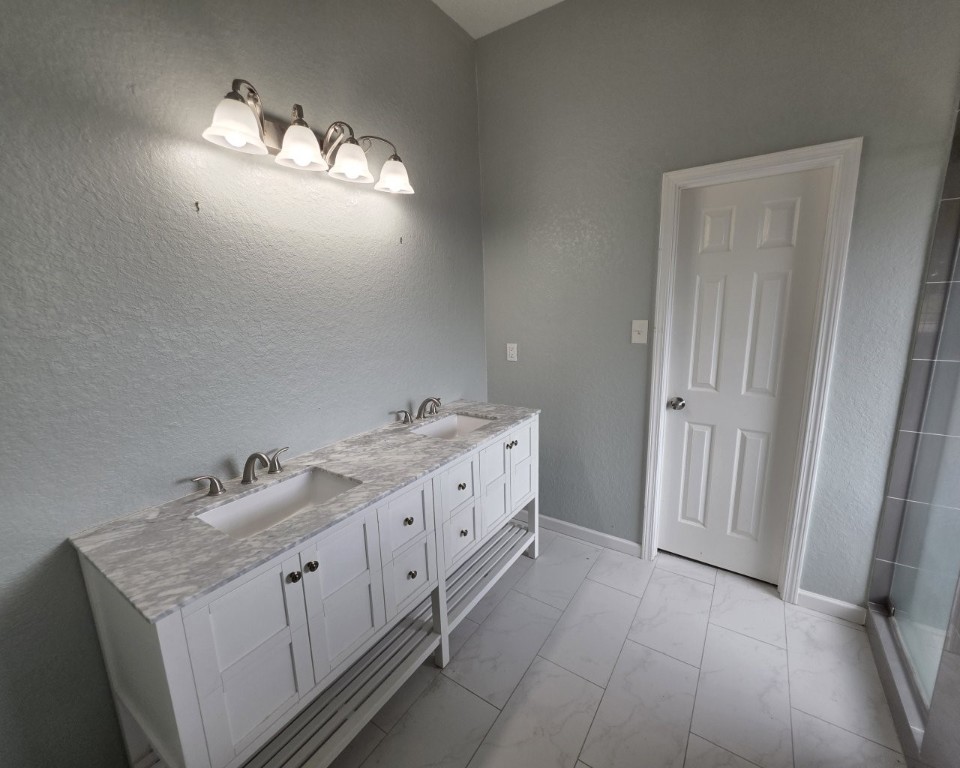 129 Corral Court Angleton, TX 77515 - Photo 14 of 26 Double sinks in the primary bathroom