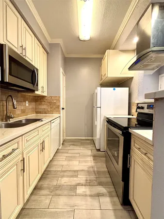 a kitchen with stainless steel appliances granite countertop a stove a sink and a microwave