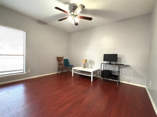 a view of a workspace with furniture and a window