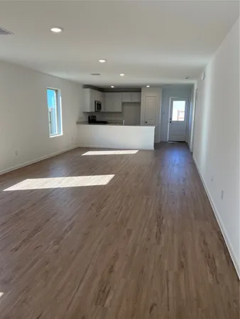 a view of a kitchen with cabinets stainless steel appliances a sink and a window