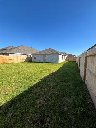 a view of a big yard with large trees