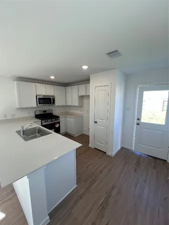 a kitchen with wooden cabinets and stainless steel appliances