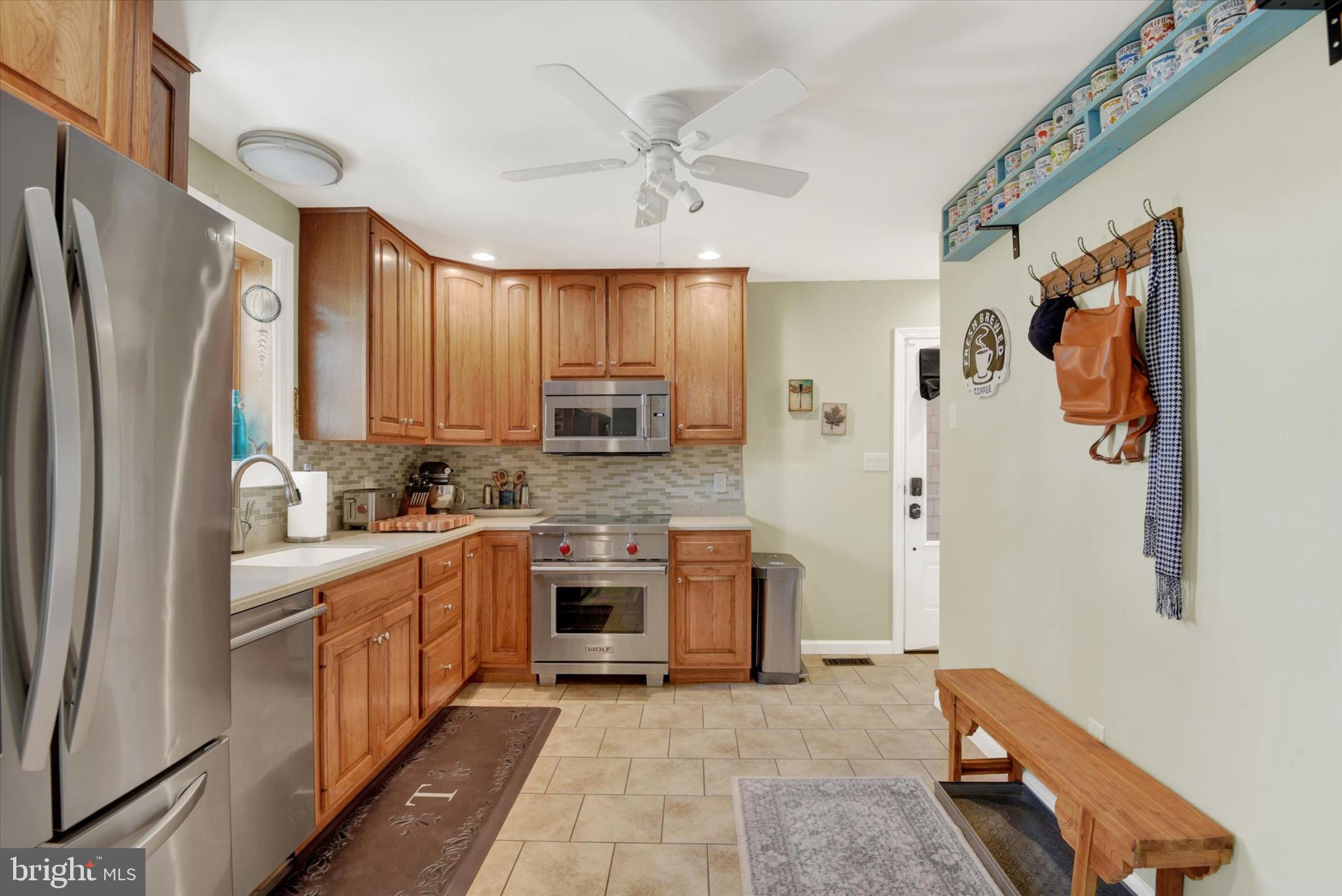 2116 Paddock Lane Finksburg, MD 21048 - Photo 6 of 35 a kitchen with stainless steel appliances granite countertop a refrigerator a stove and a sink with wooden floor