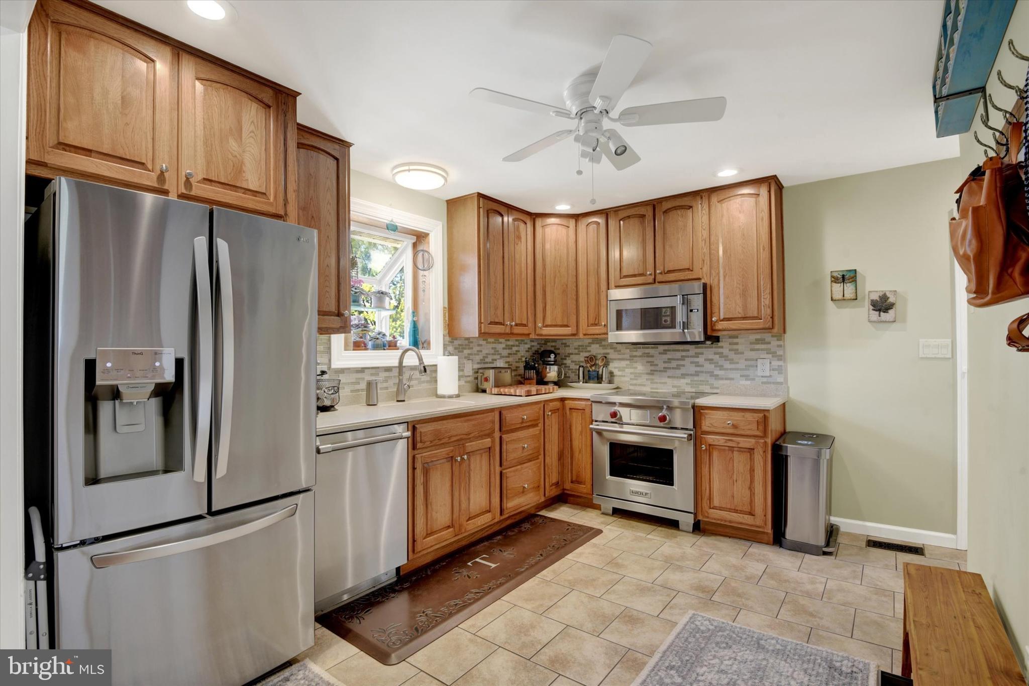 2116 Paddock Lane Finksburg, MD 21048 - Photo 7 of 35 a kitchen with stainless steel appliances granite countertop a refrigerator a stove a sink and dishwasher
