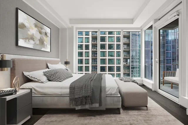 a bedroom with a bed and glass window