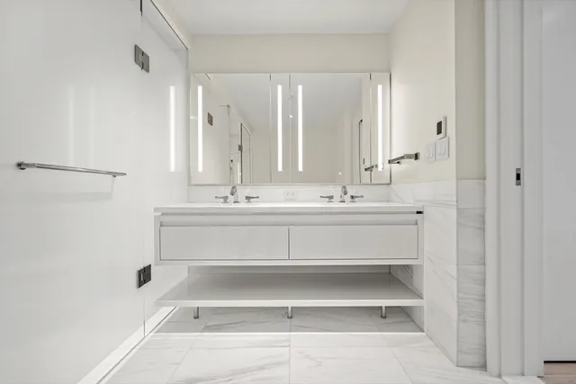 a bathroom with a sink mirror and a