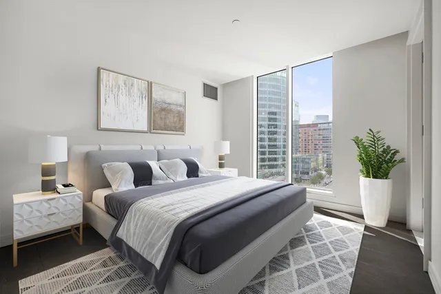 a bedroom with bed and a window