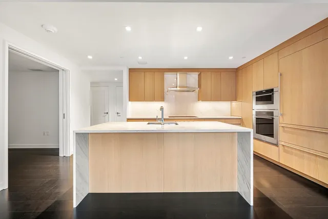 a kitchen with stainless steel appliances a sink stove and refrigerator