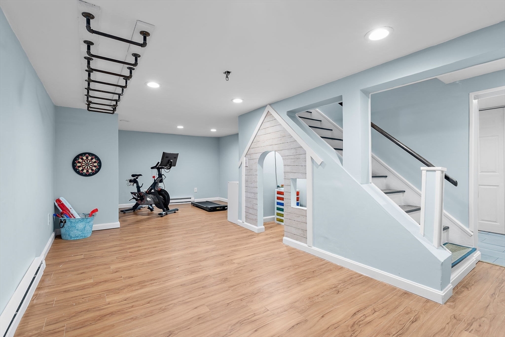 13 Mohegan Road Acton, MA 01720 - Photo 29 of 39 a view of a livingroom with wooden floor and stairs