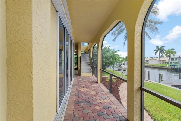 a open kitchen with stainless steel appliances kitchen island wooden floors granite counter tops and a view of living room