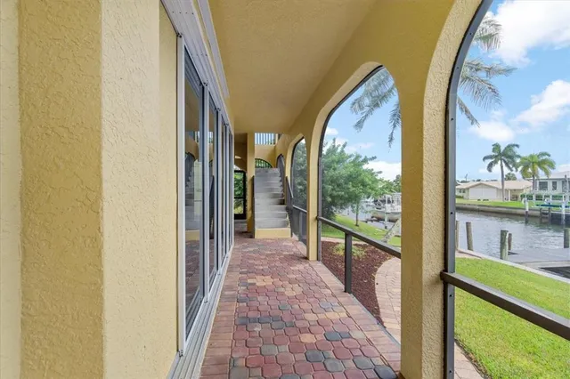 a open kitchen with stainless steel appliances kitchen island wooden floors granite counter tops and a view of living room