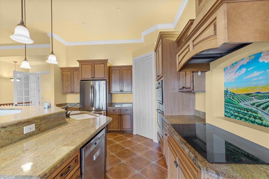 4301 Vasco Street Punta Gorda, FL 33950 - Photo 16 of 53 a kitchen with stainless steel appliances granite countertop a sink a stove and a refrigerator