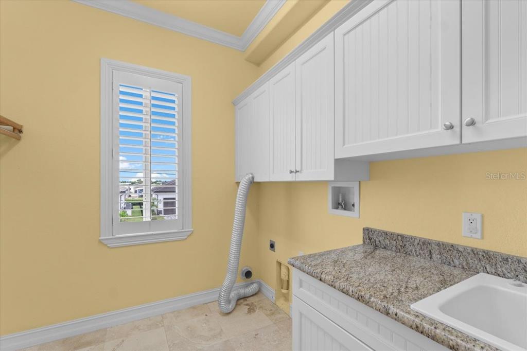 4301 Vasco Street Punta Gorda, FL 33950 - Photo 28 of 53 a kitchen with a sink cabinets and a granite counter top