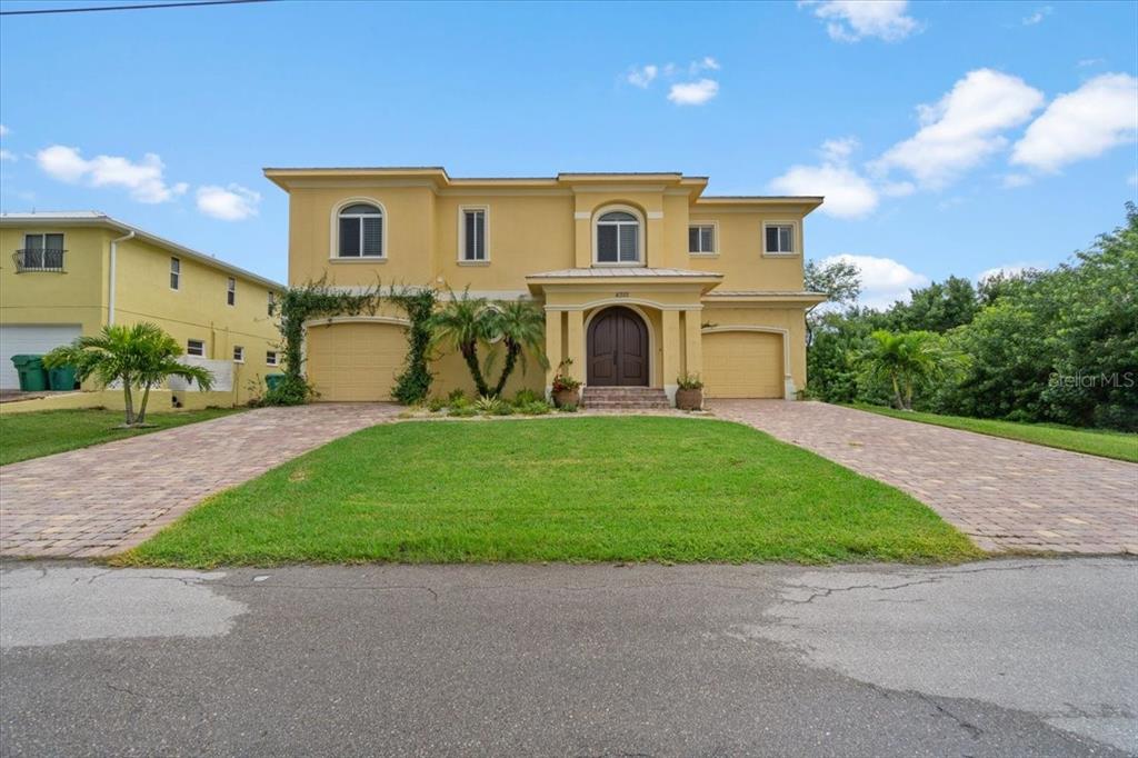 4301 Vasco Street Punta Gorda, FL 33950 - Photo 3 of 53 a front view of a house with a garden and yard