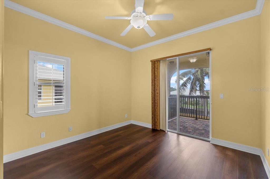4301 Vasco Street Punta Gorda, FL 33950 - Photo 32 of 53 an empty room with wooden floor ceiling fan and windows