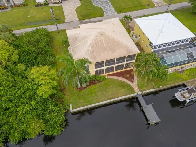 an aerial view of a house with yard swimming pool and outdoor seating