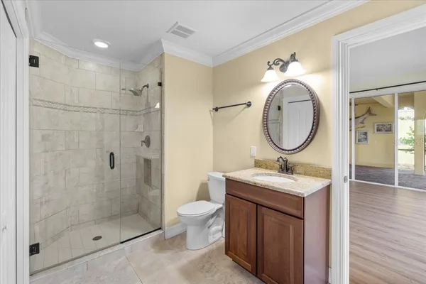 a bathroom with a sink toilet a mirror and shower