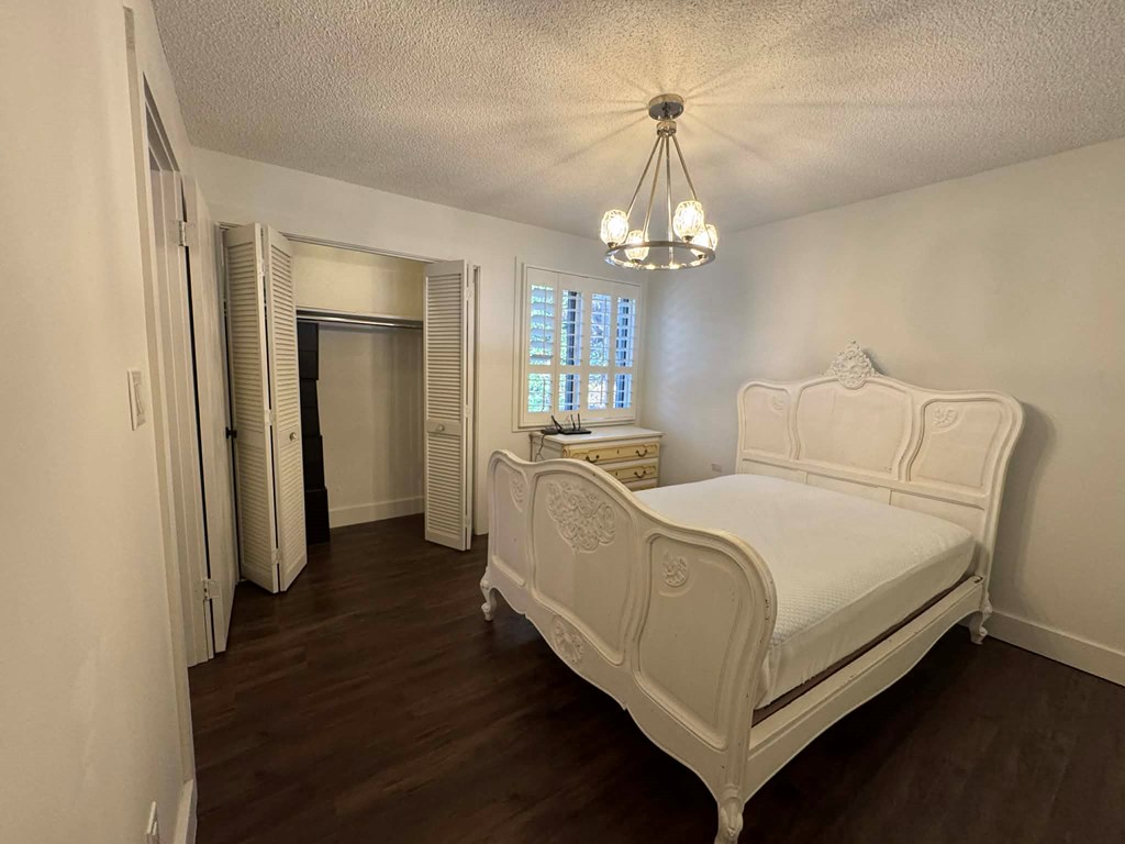 500 Marina Road Murphy, NC 28906 - Photo 17 of 57 a bed room with a bed and a chandelier