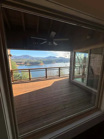 a view of a room with wooden floor and windows