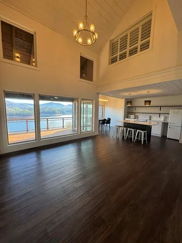 a view of a livingroom with furniture wooden floor windows and chandelier