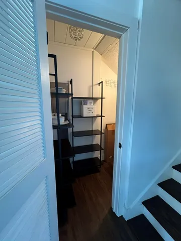 a spacious bedroom with a bed and a chandelier