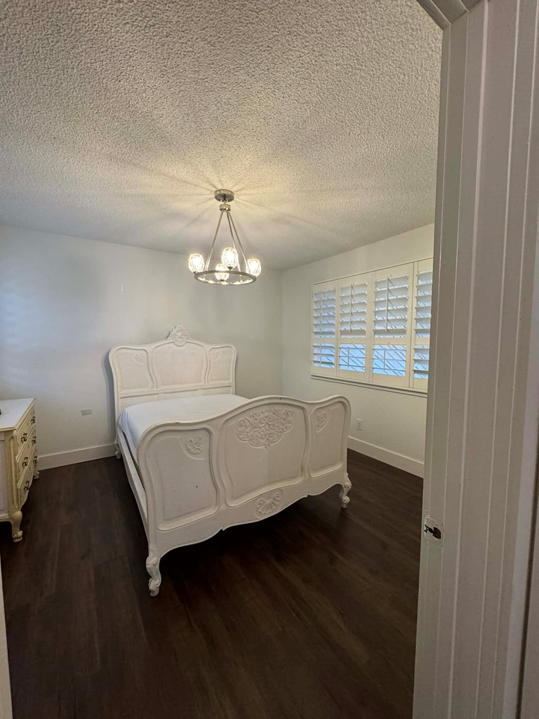 500 Marina Road Murphy, NC 28906 - Photo 28 of 57 a spacious bedroom with a bed and a chandelier
