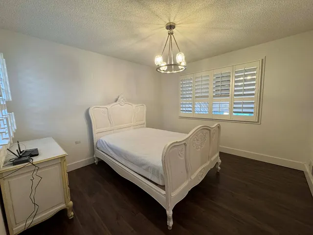 a view of a hallway with entryway wooden floor and cabinet