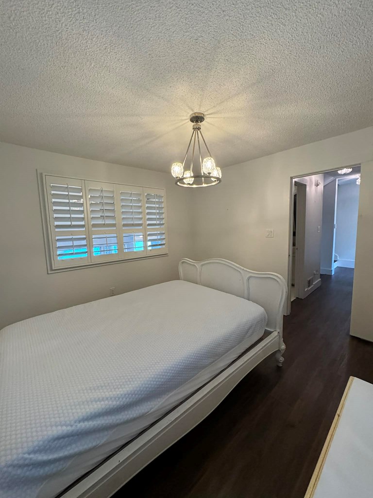 500 Marina Road Murphy, NC 28906 - Photo 31 of 57 a bedroom with a bed and a chandelier