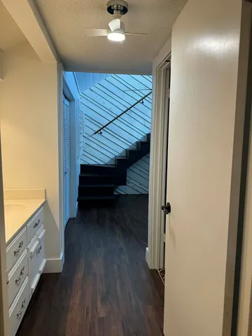 a view of entryway and hall with wooden floor