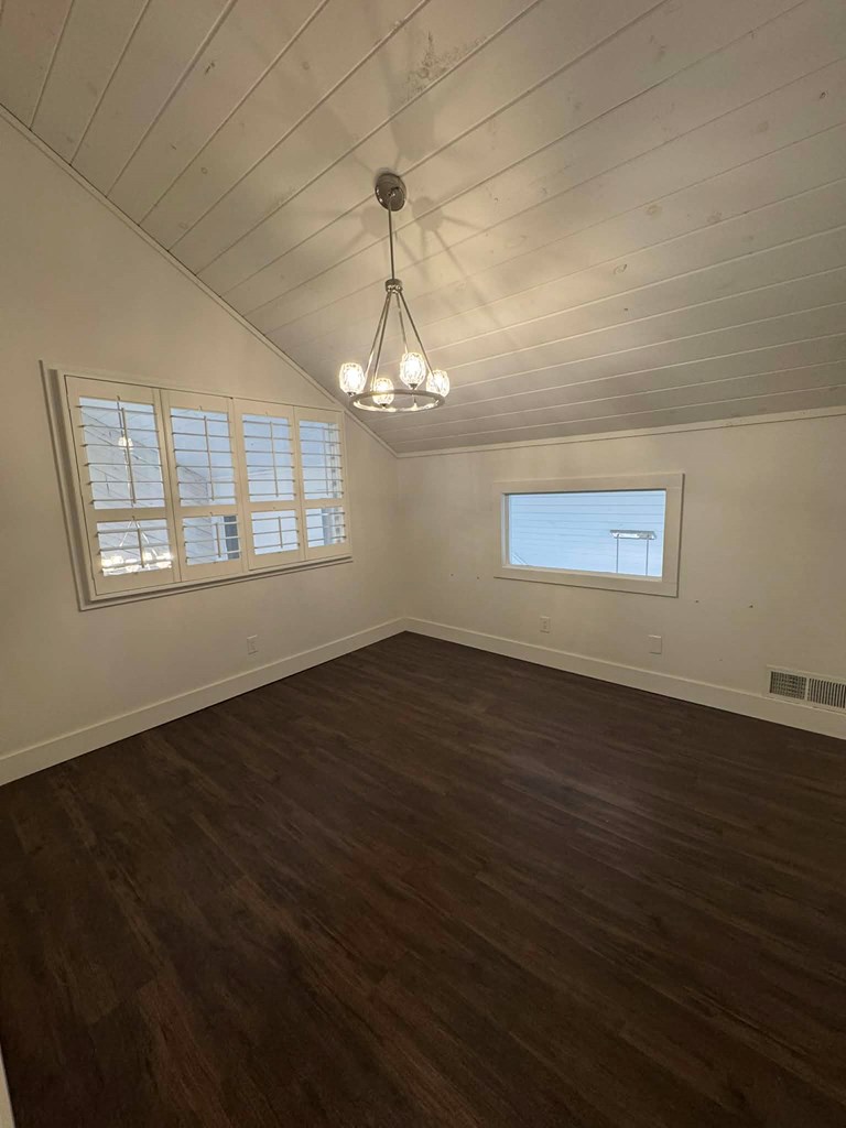 500 Marina Road Murphy, NC 28906 - Photo 36 of 57 an empty room with wooden floor chandelier and windows