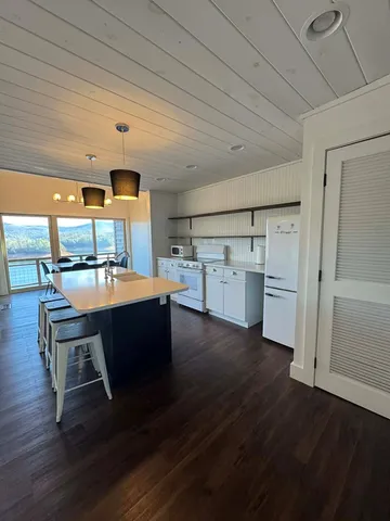 a kitchen with a sink cabinets and wooden floor