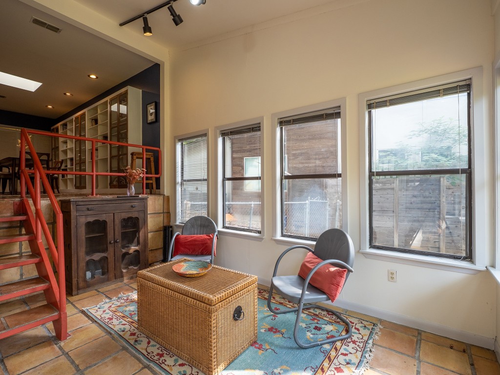 4617 Finley Drive Austin, TX 78731 - Photo 13 of 36 Living area featuring stairway, healthy amount of natural light, rail lighting, and tile patterned flooring