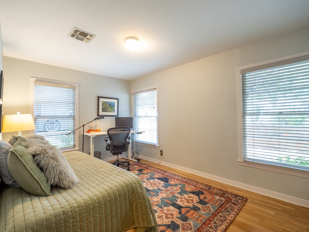 4617 Finley Drive Austin, TX 78731 - Photo 21 of 36 Bedroom featuring light wood finished floors and an office area