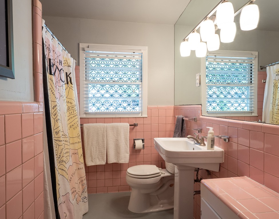 4617 Finley Drive Austin, TX 78731 - Photo 25 of 36 Full bath with plenty of natural light, tile walls, a wainscoted wall, and a shower with curtain