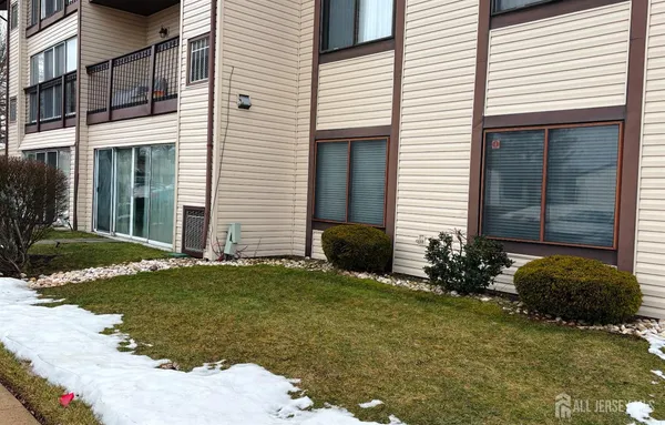a view of a house with backyard and sitting area