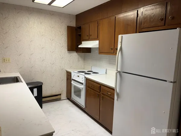 a kitchen with a refrigerator sink stove and cabinets