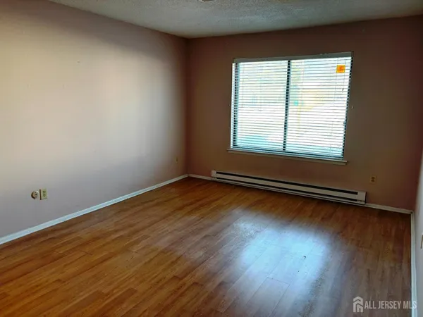 a view of a room with wooden floor and window