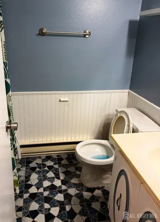 a bathroom with a sink a toilet and a mirror