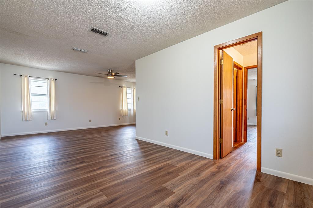 501 Endora Dublin, TX 76446 - Photo 21 of 39 an empty room with wooden floor and a window