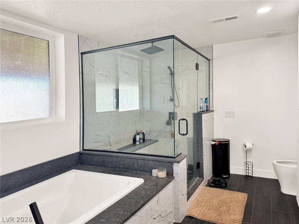 9393 North 93rd Highway Caliente, NV 89008 - Photo 17 of 41 Luxurious bathing quarters feature a contemporary soaking tub and a sleek, glass-enclosed shower.