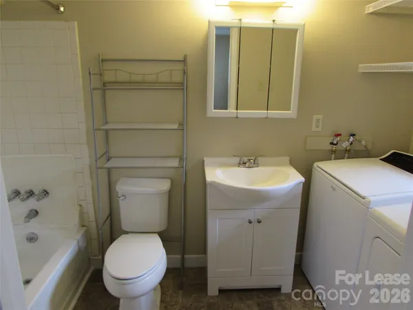 a bathroom with a toilet sink and shower