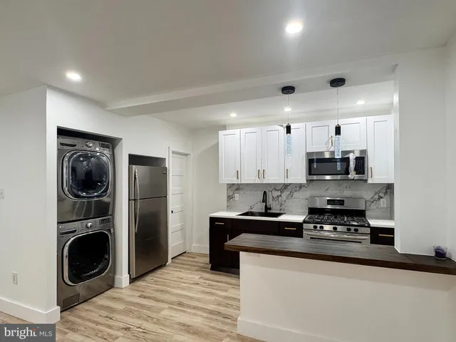 a kitchen with a sink a stove and refrigerator