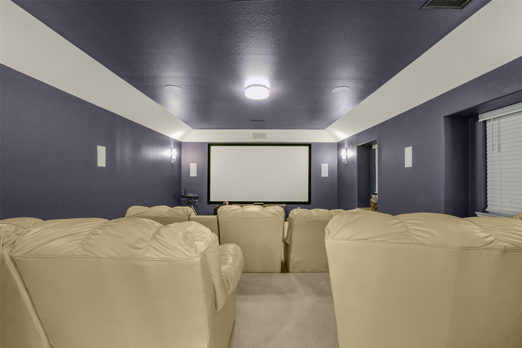 2018 Grove Terrace Lane Manvel, TX 77578 - Photo 32 of 50 INCLUDED cozy home theater room with plush beige seating and a large screen, set against a backdrop of deep blue walls and soft lighting, perfect for entertaining. All theater equipment included.