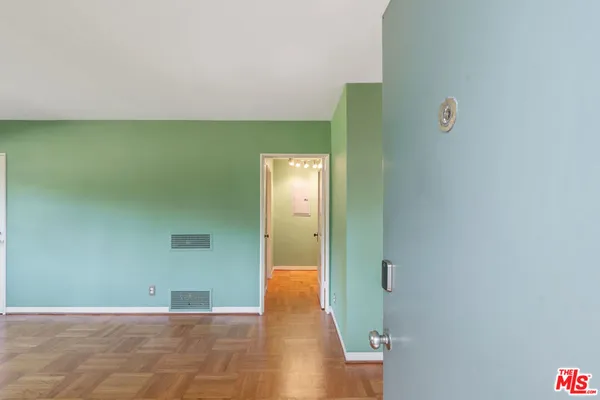 a view of a big room with wooden floor and closet
