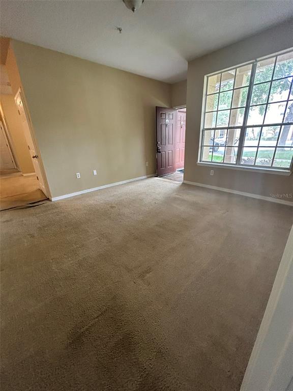 823 Grand Regency Point, Unit 102 Altamonte Springs, FL 32714 - Photo 5 of 12 an empty room with windows
