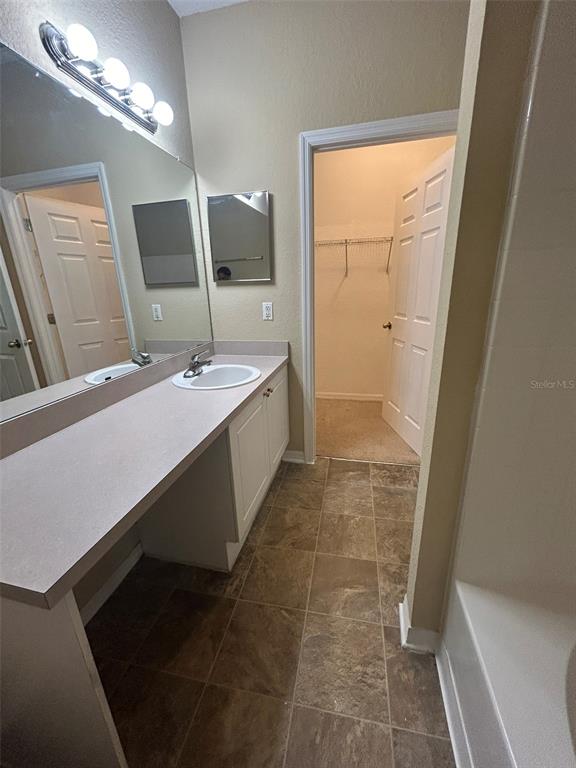 823 Grand Regency Point, Unit 102 Altamonte Springs, FL 32714 - Photo 7 of 12 a bathroom with a sink and a mirror