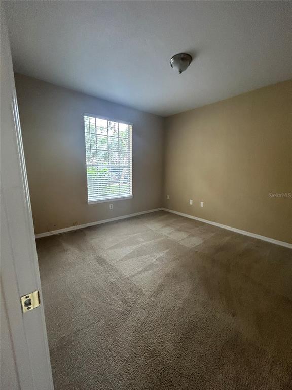 823 Grand Regency Point, Unit 102 Altamonte Springs, FL 32714 - Photo 9 of 12 an empty room with a window