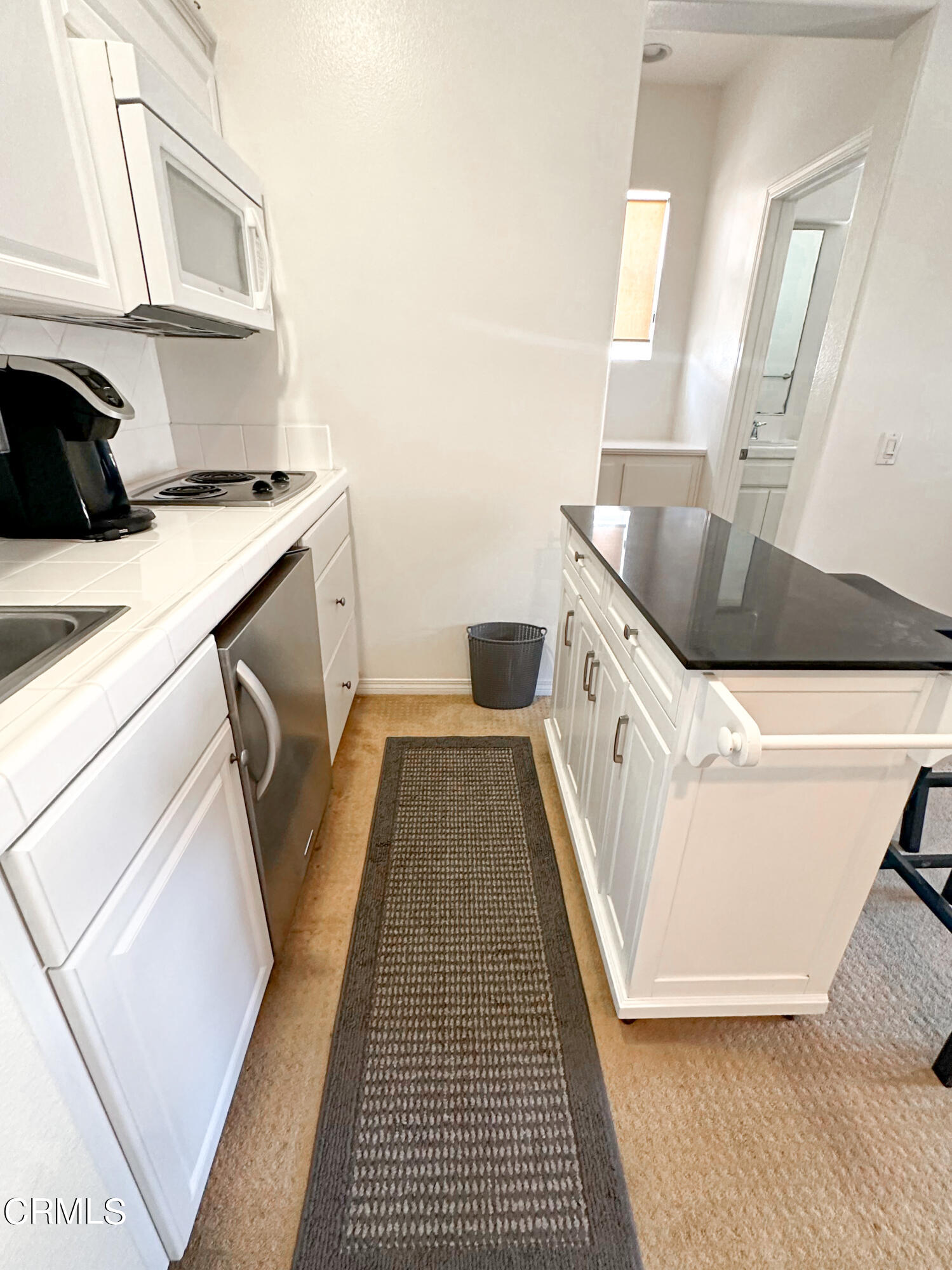 726 Owens River Drive, Unit 2 Oxnard, CA 93036 - Photo 7 of 10 a kitchen with granite countertop a sink and cabinets
